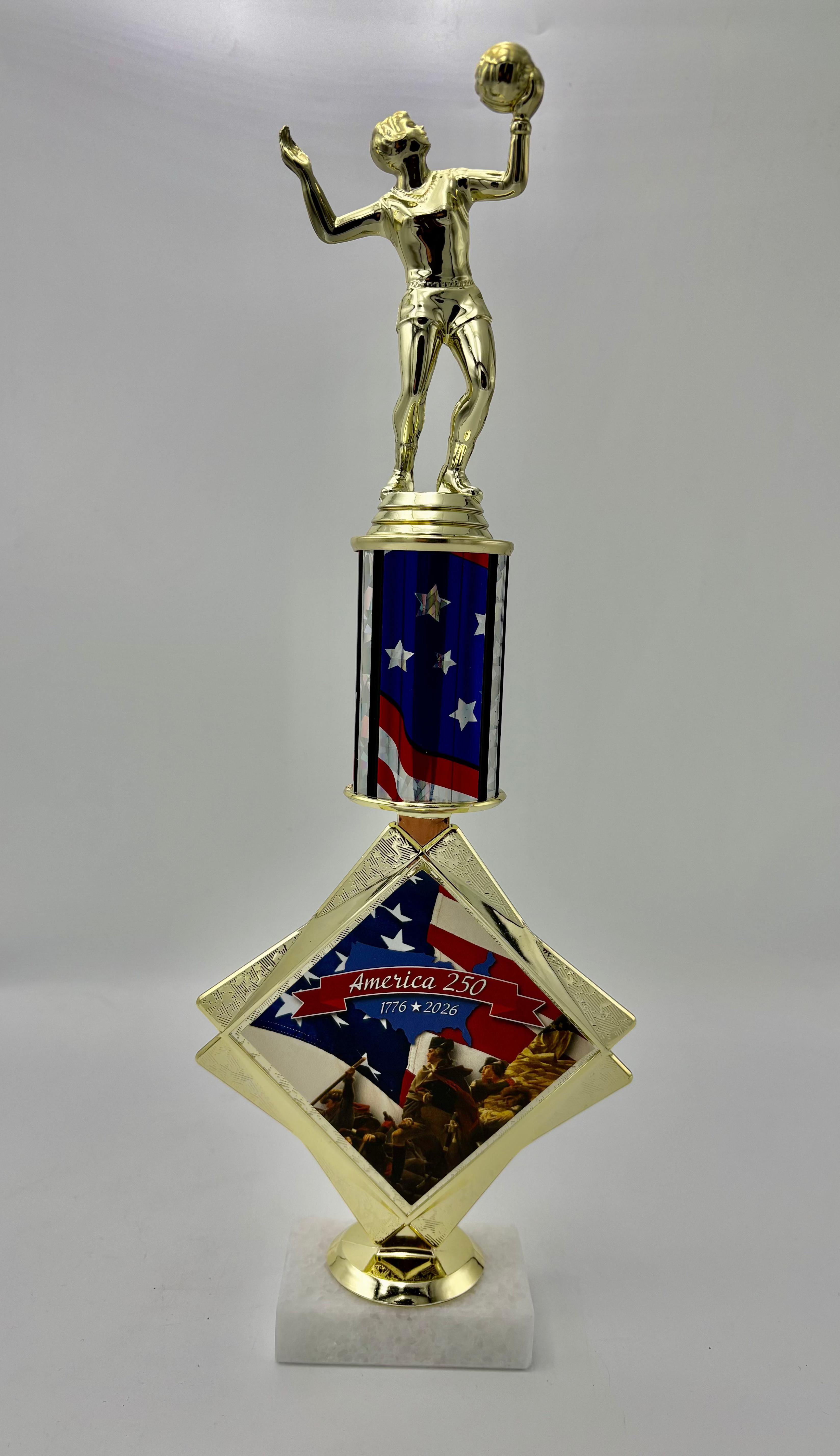 Gold trophy with American flag design on a gray background