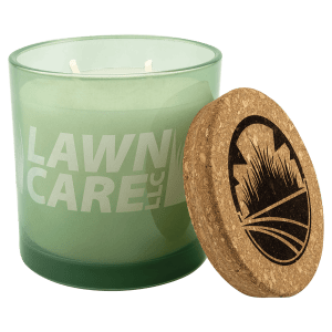 Citronella candle with 'Lawn Care' text and cork lid on a green glass holder