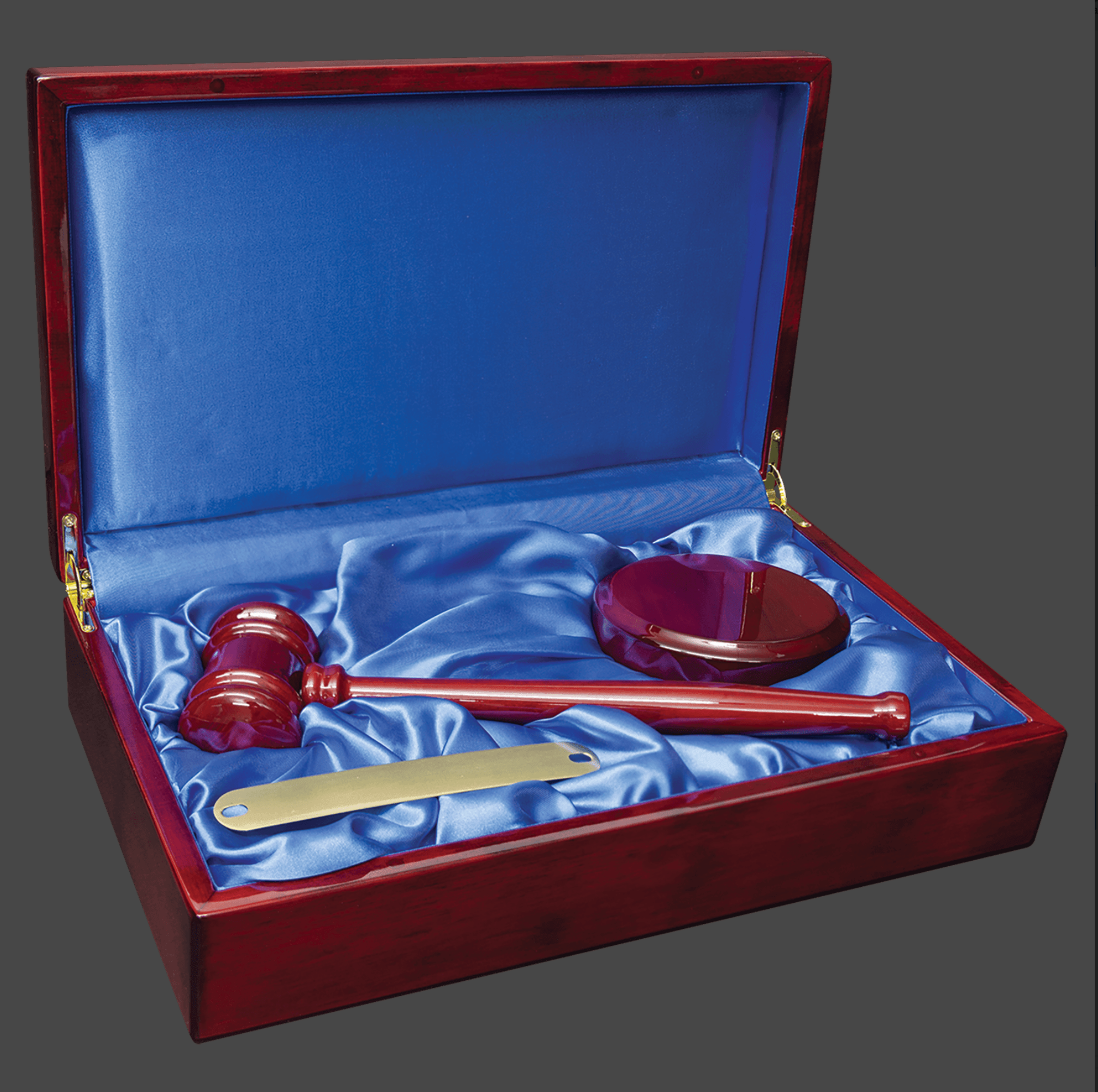 A Rosewood Piano Finish Directors Gavel Set inside a wooden case with blue velvet lining. The set includes a 10 inch gavel, a sounding block, and a brass gavel band.