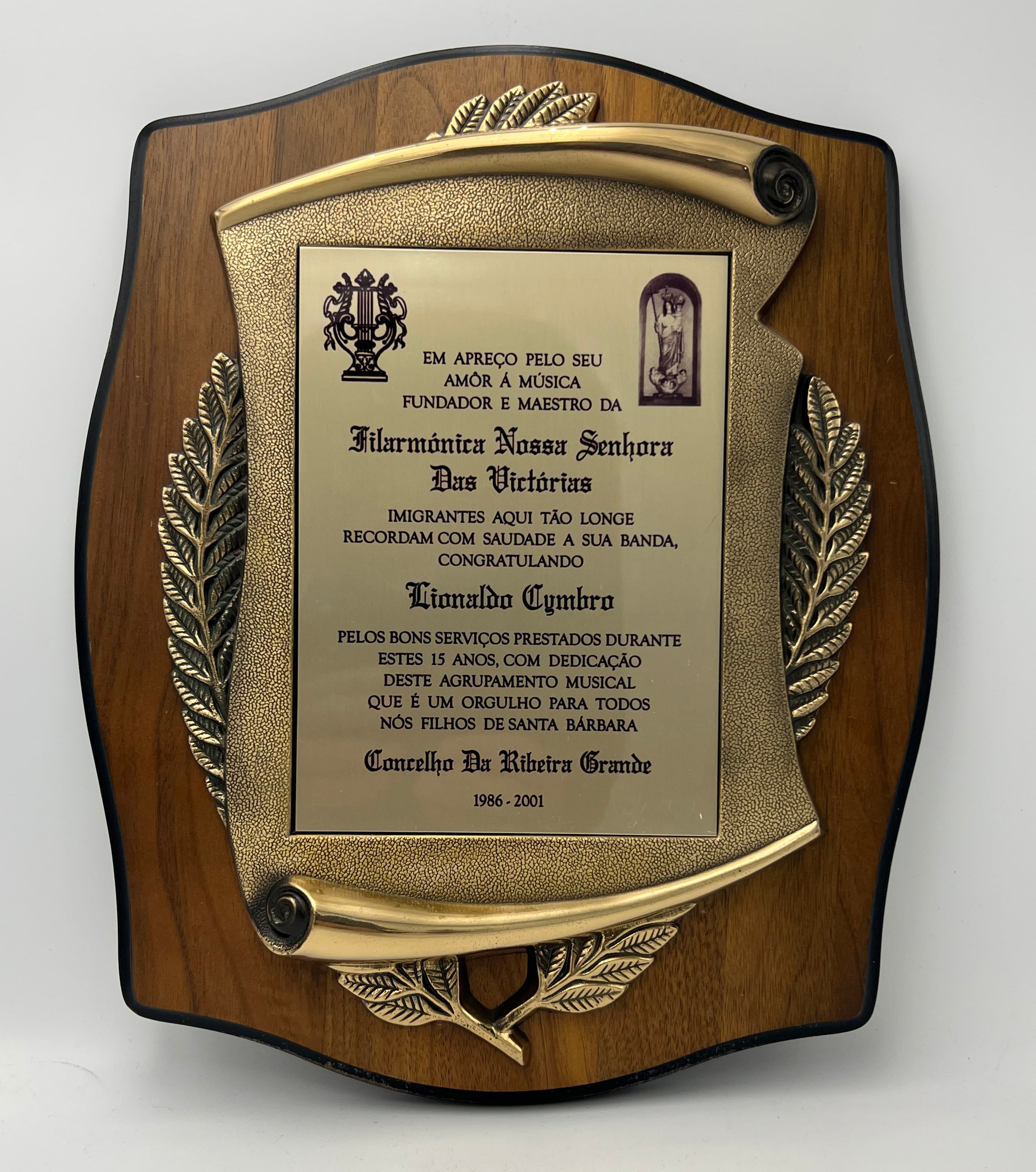 Decorative plaque with engraved text on a wooden base