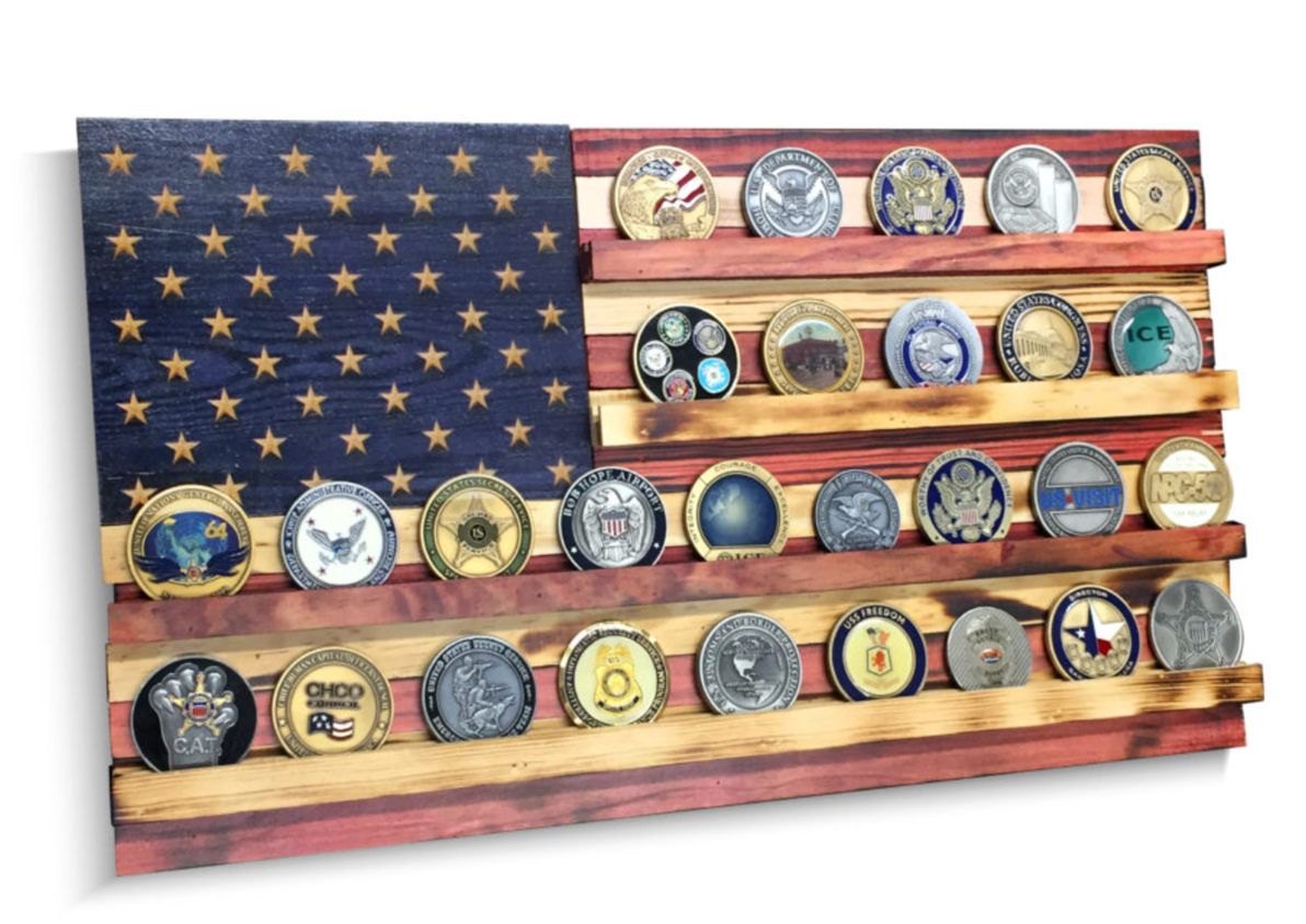 Wooden flag display with coins on a white background