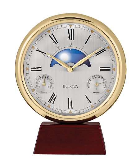 Bulova clock with gold casing and wooden base on a white background