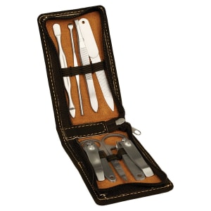 A 7-Piece Laserable Leatherette Manicure Gift Set displayed open with various manicure tools like scissors, tweezers, and files, housed in a black leatherette case.