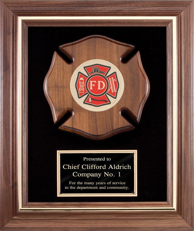 Wooden plaque with a fire department emblem and engraved text, framed in brown wood.