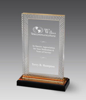 Acrylic award with engraved text on a gray background with a gold reflective bottom